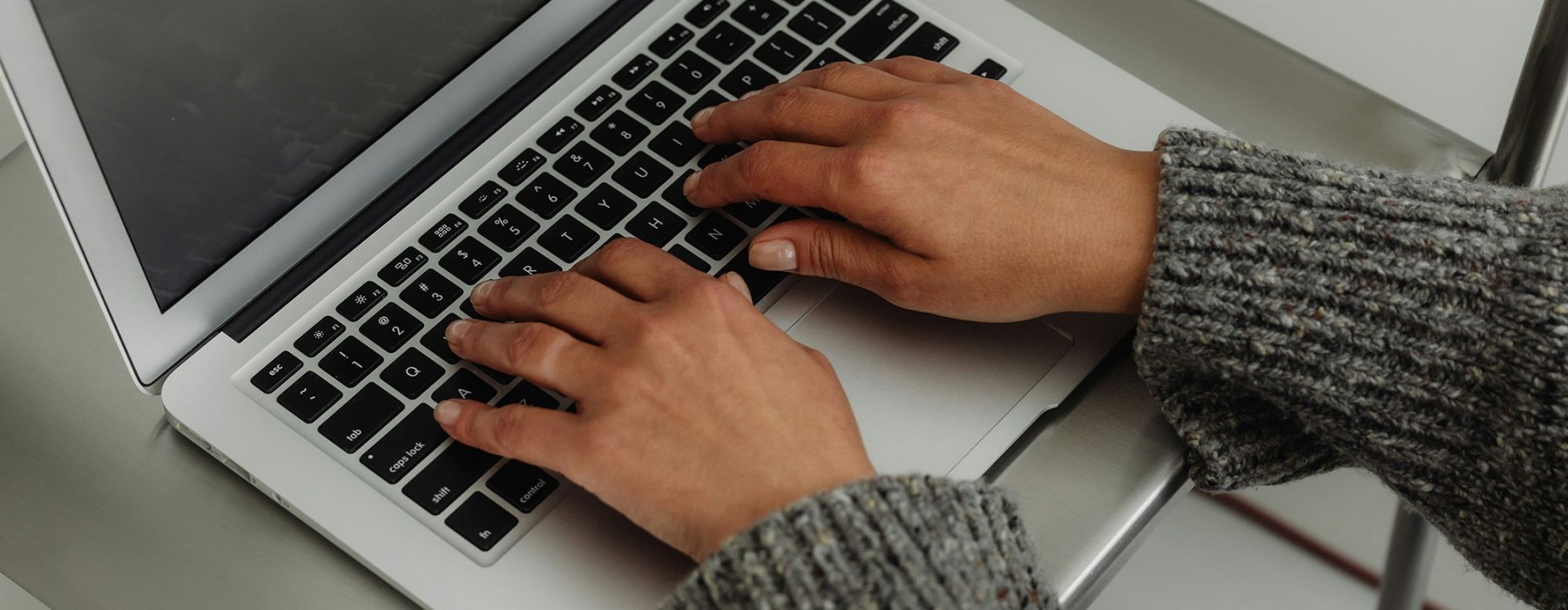 a person typing on a laptop
